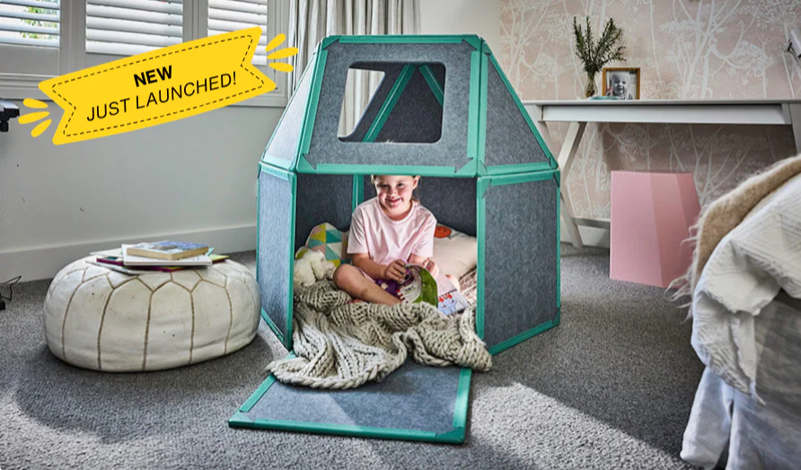Children's playhouse with a child inside, labeled 'NEW JUST LAUNCHED!' in a room setting.