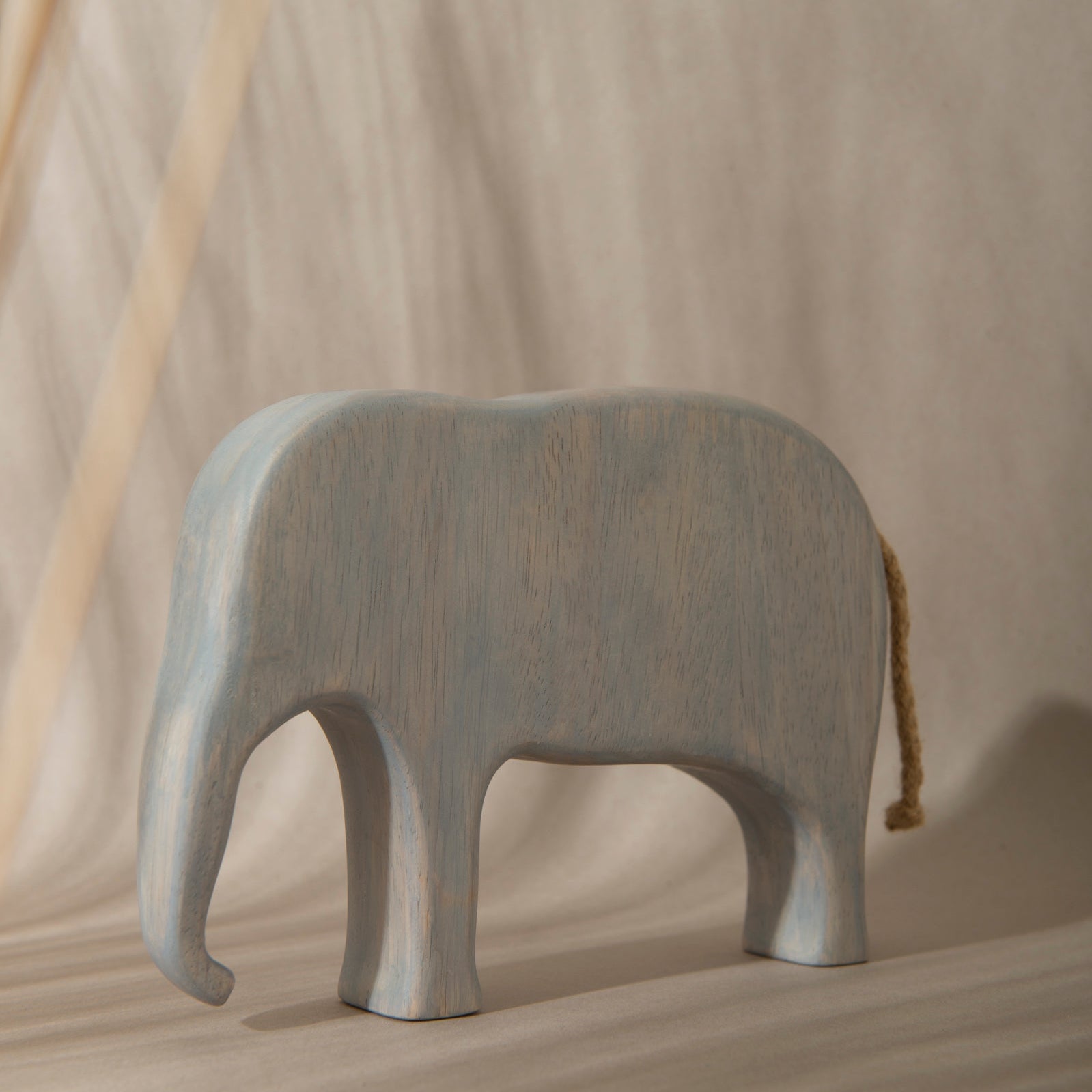 Gray elephant figurine on a beige background