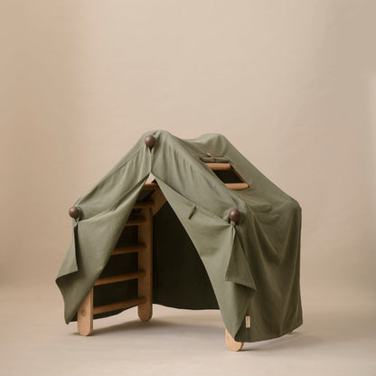Green tent-like structure on wooden legs against a beige background