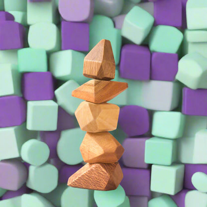Stack of wooden geometric shapes on a beige background