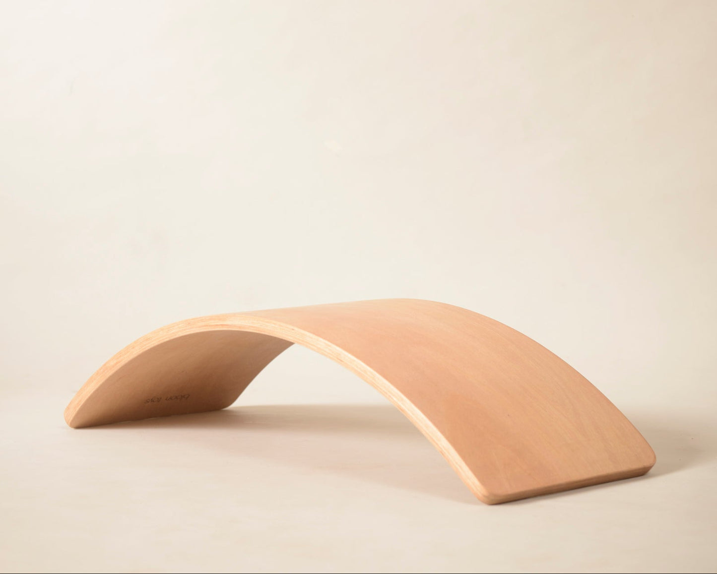 Wooden arch-shaped object on a beige background