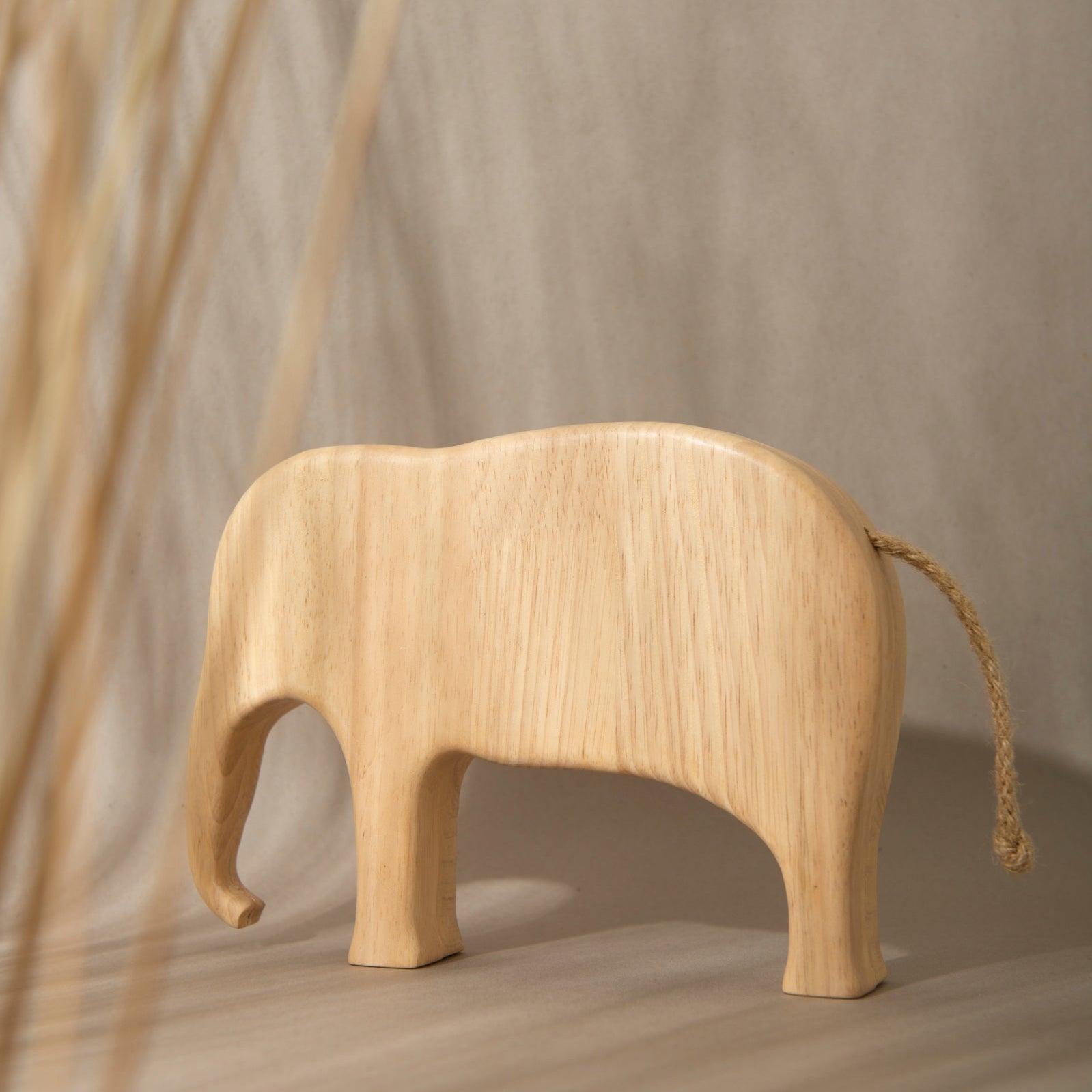 Wooden elephant toy on a neutral background
